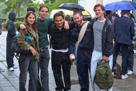 GTE students smiling in a group photo at orientation with umbrellas
