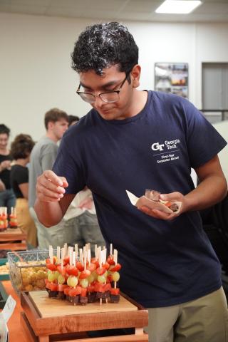 Student enjoying appetizers at the GTE fall meet and greet